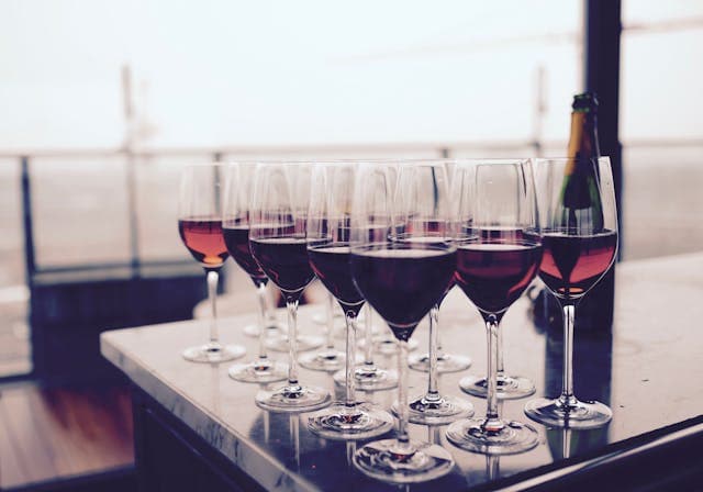 Wine being poured at a warm interior table